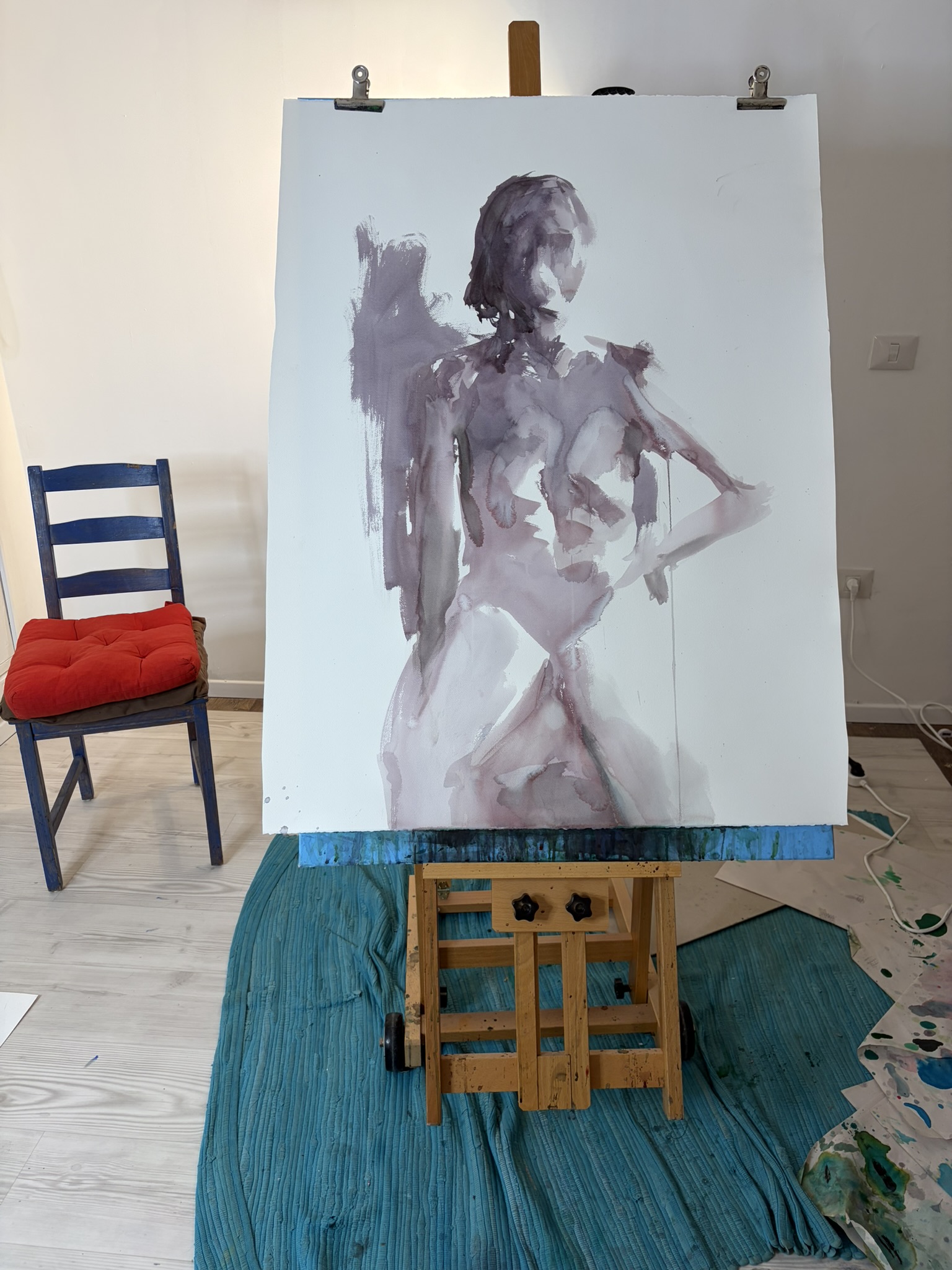Watercolor painting displayed on an easel in the studio